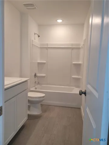 a bathroom with a toilet a sink and bathtub