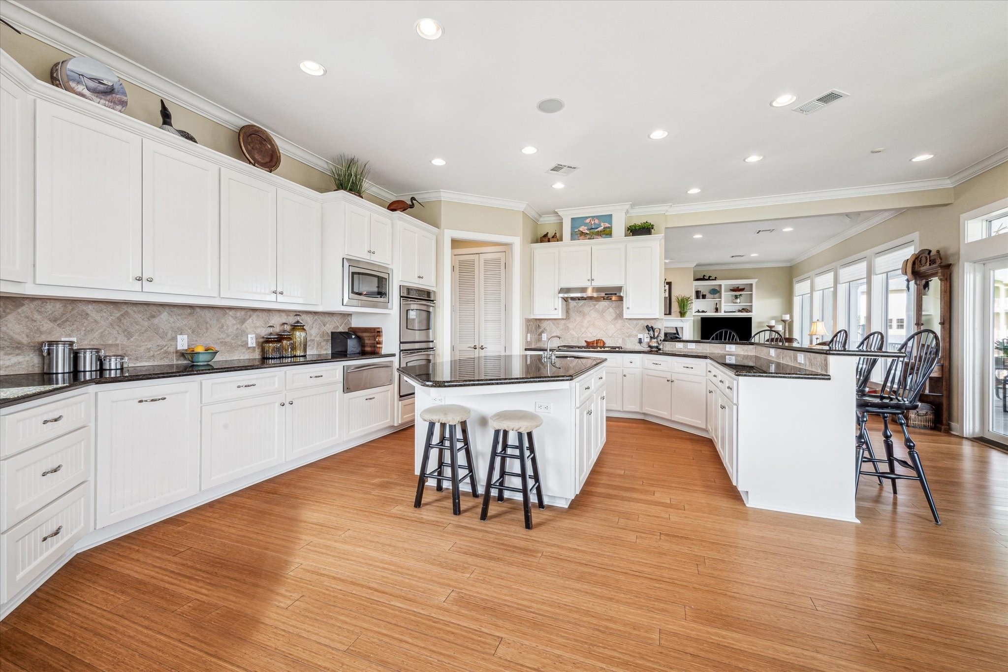 1 Shell Key Hitchcock, TX 77563 - Photo 20 of 50 a large white kitchen with lots of counter space wooden floor and appliances