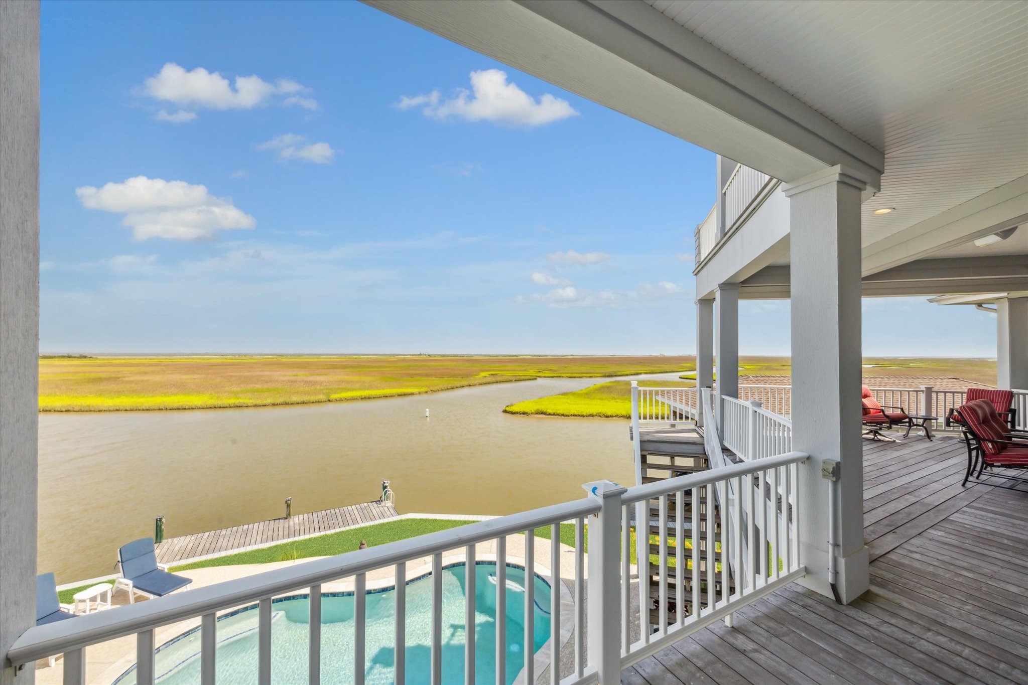 1 Shell Key Hitchcock, TX 77563 - Photo 40 of 50 Overlooking the scenic beauty of West Galveston Bay, it offers a seamless extension of the indoor living space, inviting you to enjoy breathtaking sunsets, warm Gulf breezes, and the laid-back luxury of life on the water. Whether hosting gatherings or unwinding with a from the day, this patio embodies the relaxed, waterfront lifestyle that defines West Galveston Bay living