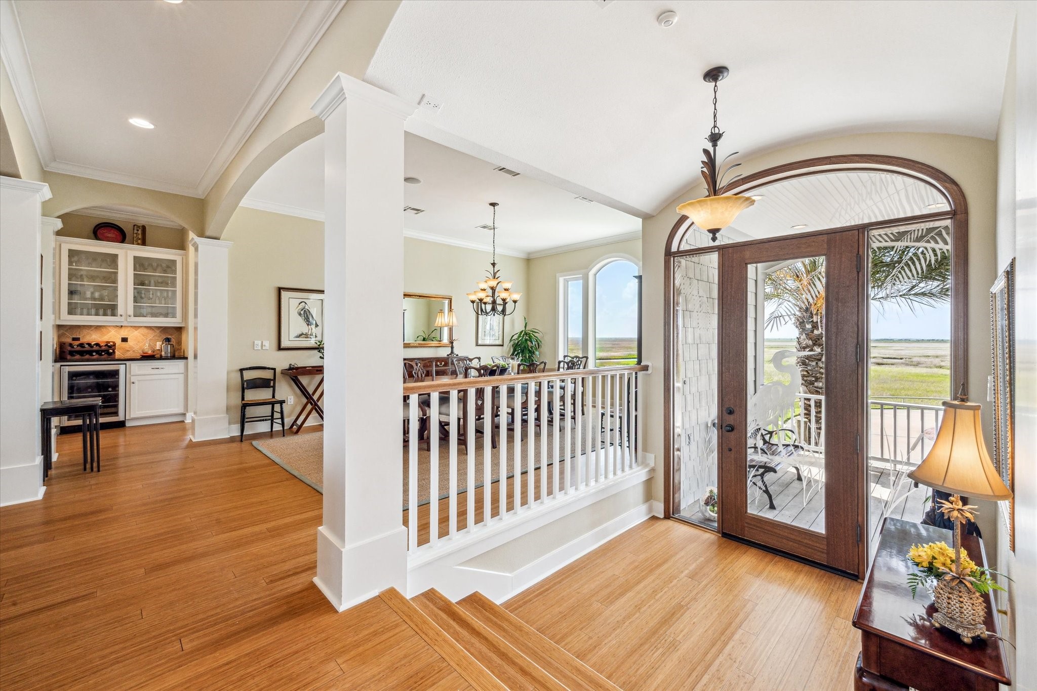 1 Shell Key Hitchcock, TX 77563 - Photo 9 of 50 This elegant entryway is filled with abundant natural light streaming through a large arched glass door. Classic architectural details, including column accents and wide trim, lend a sense of timeless elegance throughout this coastal retreat