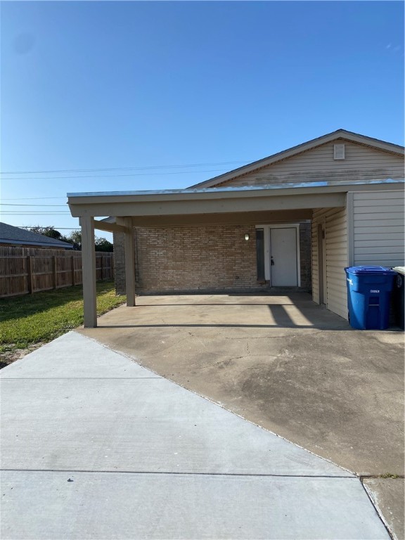 313 Easy Street, Unit A Corpus Christi, TX 78418 - Photo 2 of 16 a front view of a house with a yard and garage