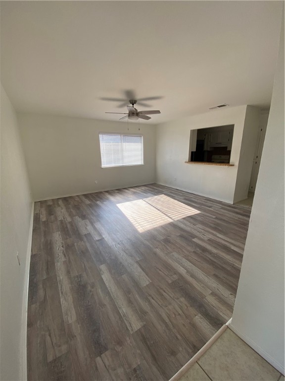 313 Easy Street, Unit A Corpus Christi, TX 78418 - Photo 3 of 16 an empty room with wooden floor and windows