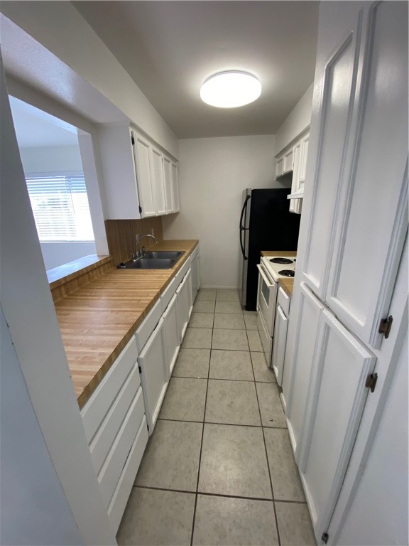 313 Easy Street, Unit A Corpus Christi, TX 78418 - Photo 6 of 16 a kitchen with granite countertop a stove a sink and a refrigerator