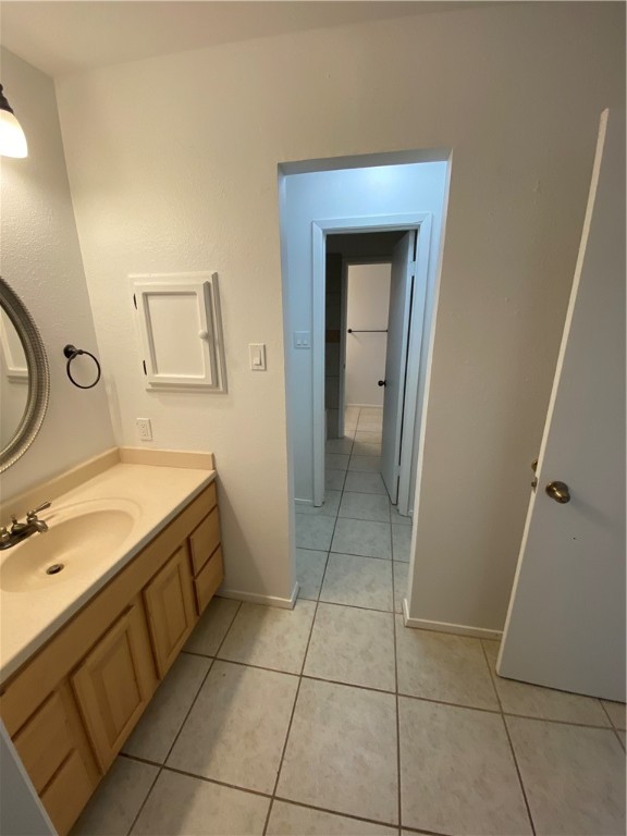 313 Easy Street, Unit A Corpus Christi, TX 78418 - Photo 8 of 16 a bathroom with a granite countertop sink a mirror and a toilet