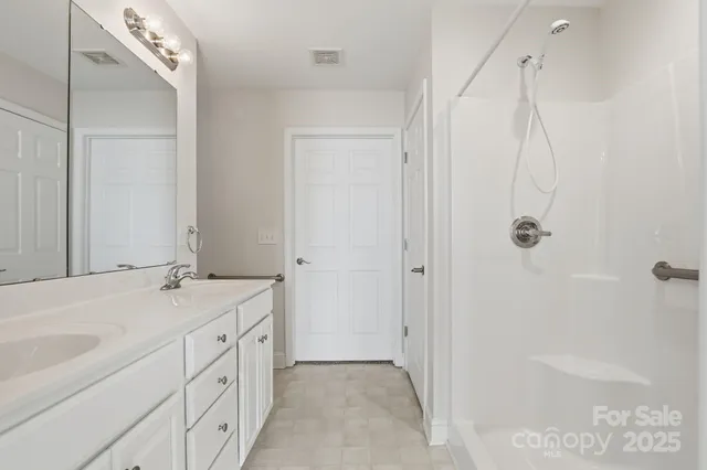a bathroom with a granite countertop sink a mirror and a bathtub