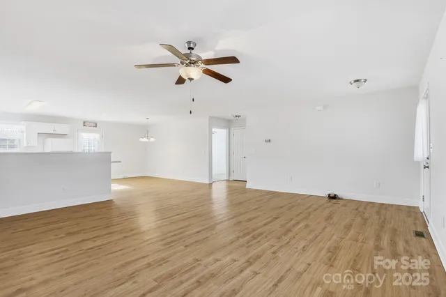 a view of a room with wooden floor and window