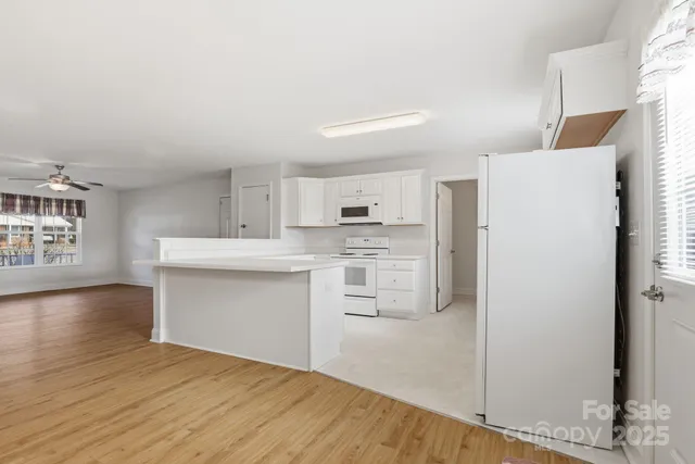 a kitchen with stainless steel appliances a refrigerator sink and cabinets