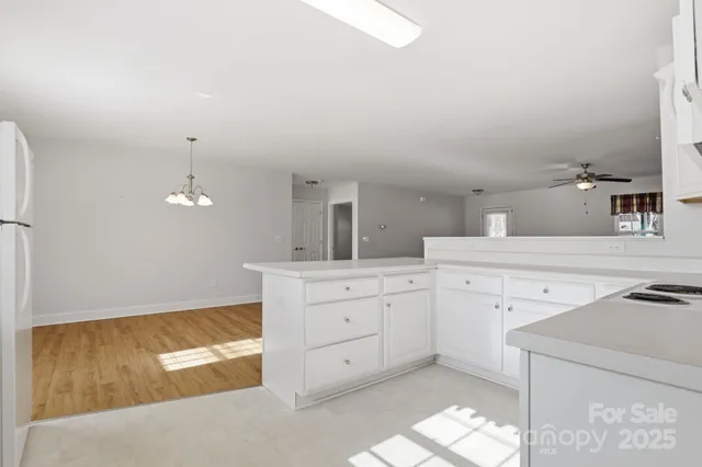 a kitchen with cabinets appliances and a counter space