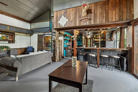 a living room with furniture and kitchen