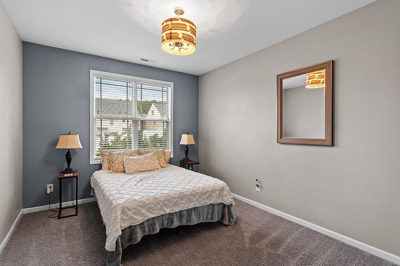 2929 Britmass Drive Raleigh, NC 27616 - Photo 17 of 35 a bedroom with a bed and a window