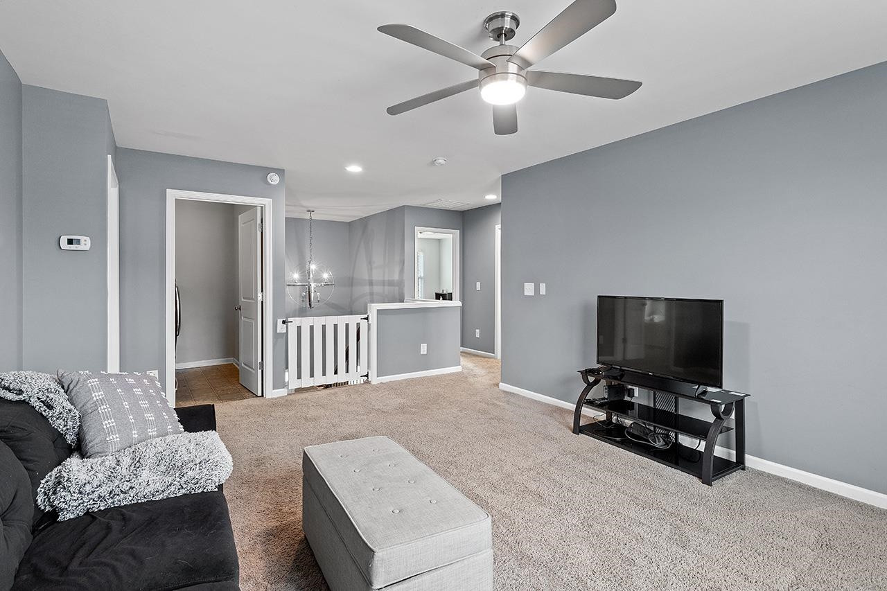 2929 Britmass Drive Raleigh, NC 27616 - Photo 20 of 35 a living room with furniture and a flat screen tv