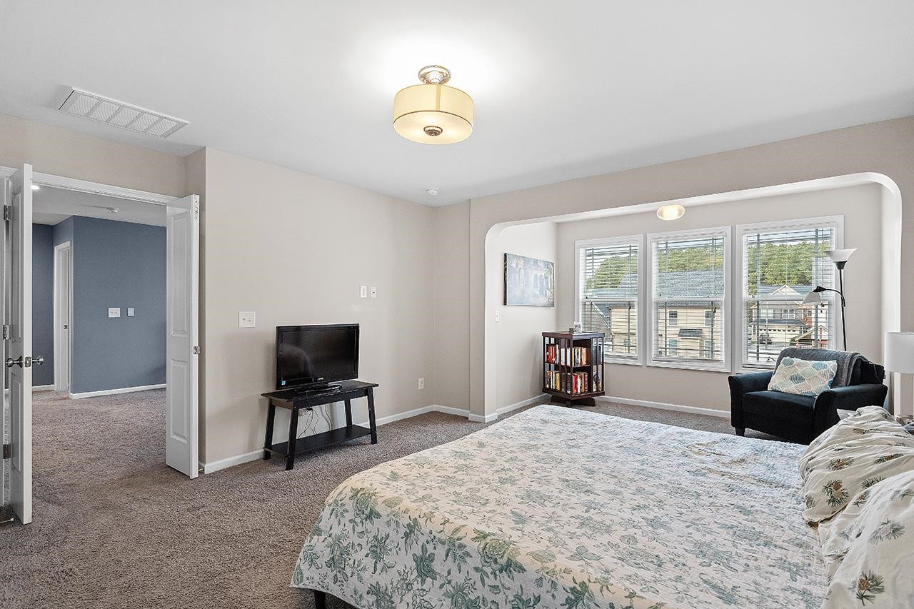 2929 Britmass Drive Raleigh, NC 27616 - Photo 23 of 35 a bedroom with a bed and furniture