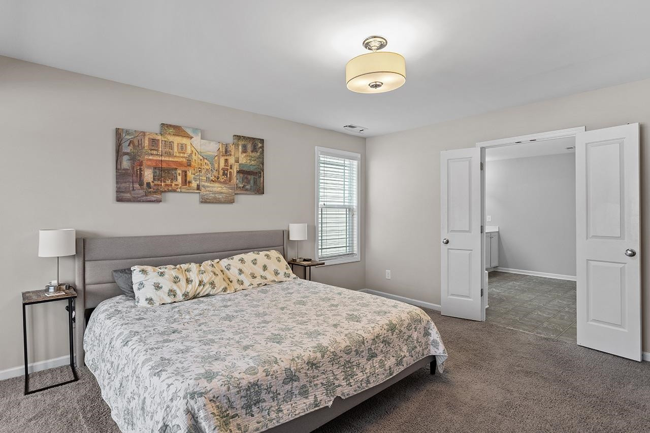 2929 Britmass Drive Raleigh, NC 27616 - Photo 24 of 35 a bedroom with a bed and a window