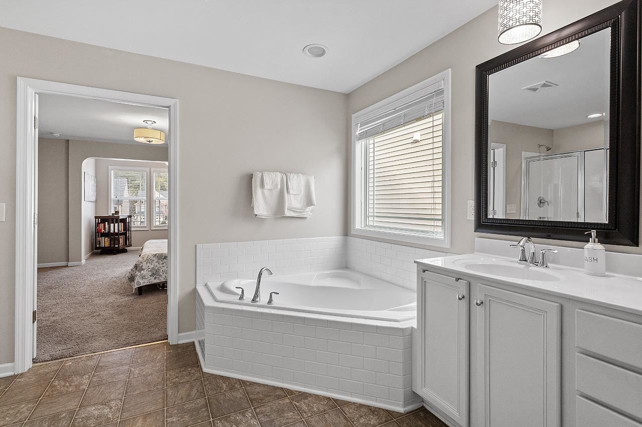 2929 Britmass Drive Raleigh, NC 27616 - Photo 27 of 35 a spacious bathroom with a tub sink and mirror