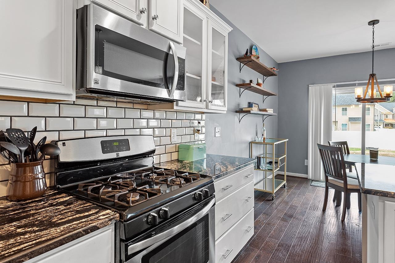 2929 Britmass Drive Raleigh, NC 27616 - Photo 5 of 35 a kitchen with stainless steel appliances a stove a sink and a microwave
