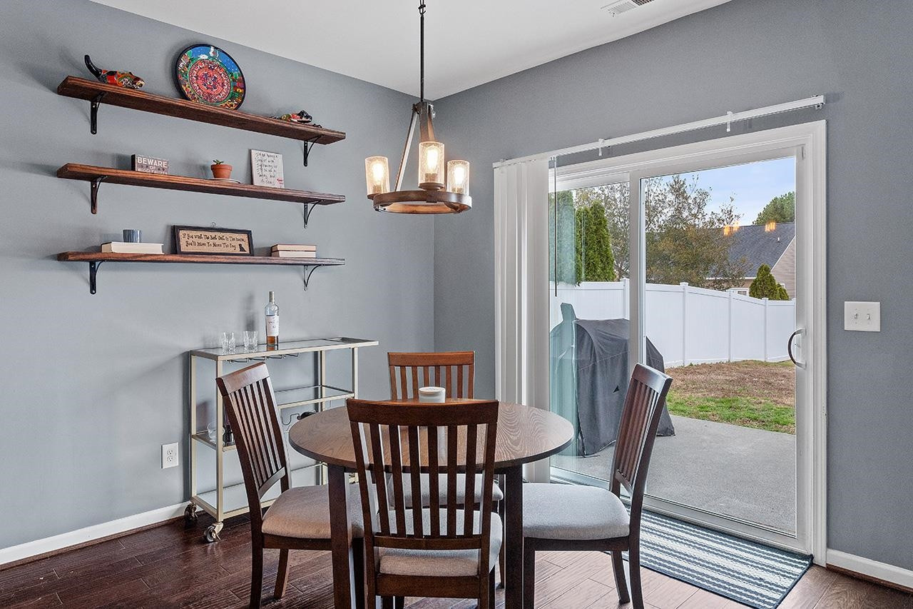 2929 Britmass Drive Raleigh, NC 27616 - Photo 10 of 35 a view of a dining room with furniture a chandelier and wooden floor
