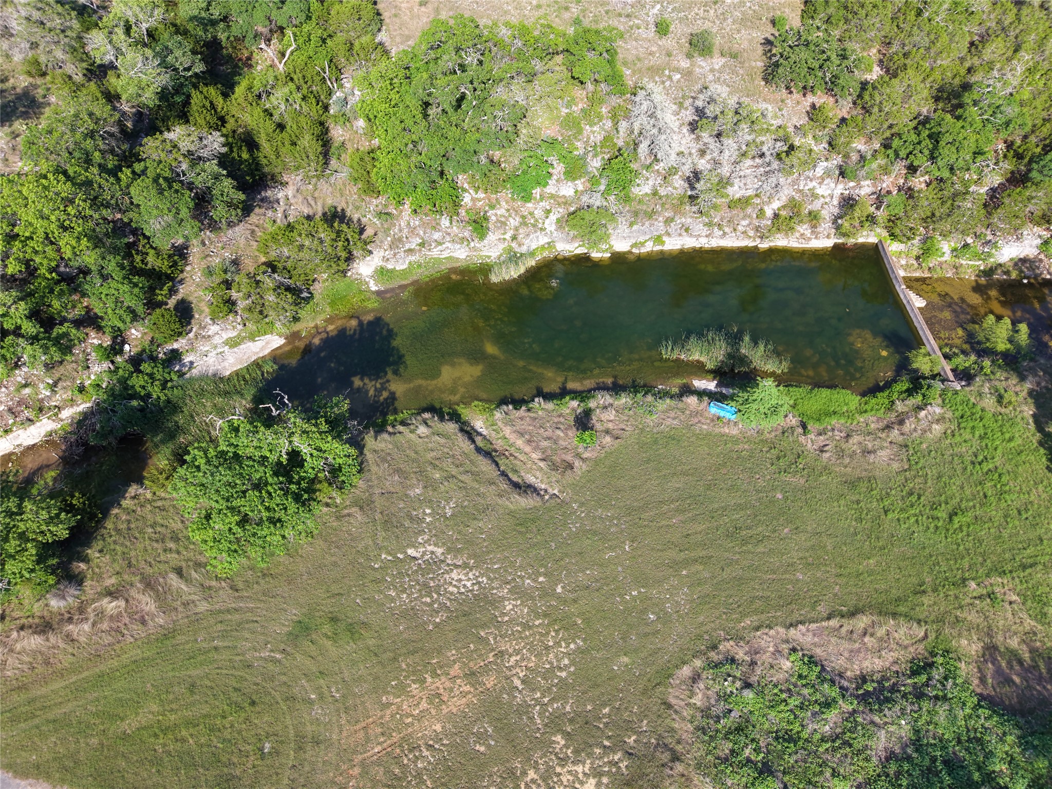 1292 Upper Turtle Creek Road Kerrville, TX 78028 - Photo 38 of 40 Discover a tranquil stream meandering through a verdant landscape, offering serene natural beauty.