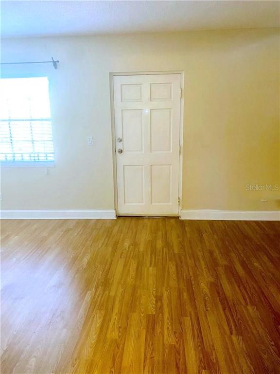 120 South Church Avenue, Unit 209 Tampa, FL 33609 - Photo 3 of 11 a view of an empty room with wooden floor and a window