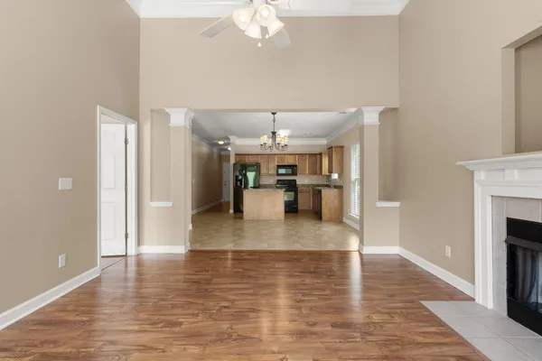 a view of a living room and kitchen with furniture appliances