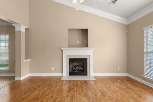 a living room with a fireplace and wooden floor