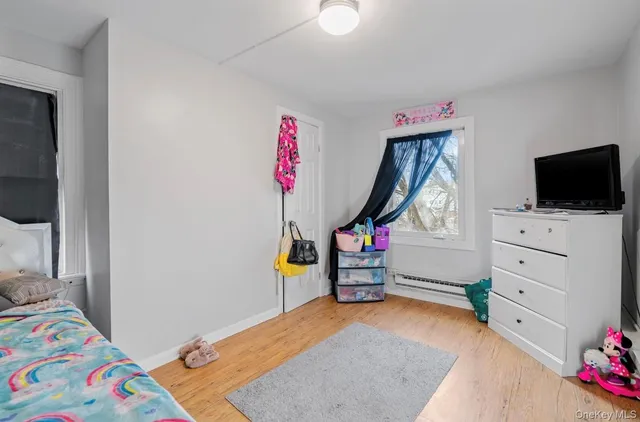 a bedroom with furniture and a flat screen tv
