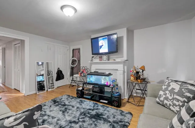 a living room with furniture a flat screen tv and a fireplace