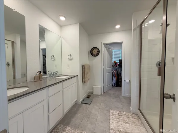 a bathroom with a double vanity sink and a mirror