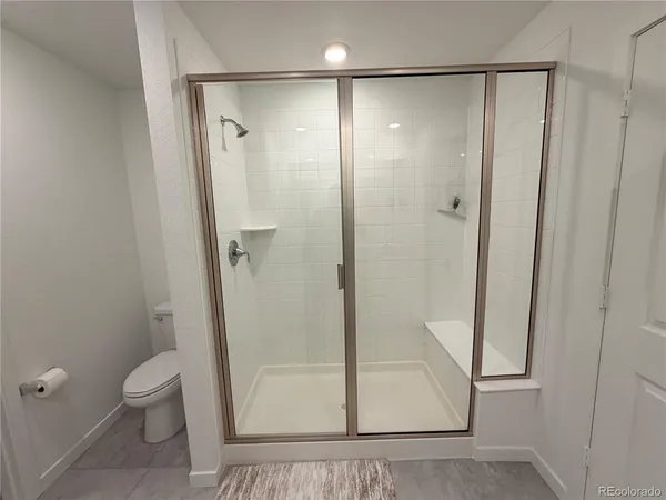 a bathroom with a glass door shower