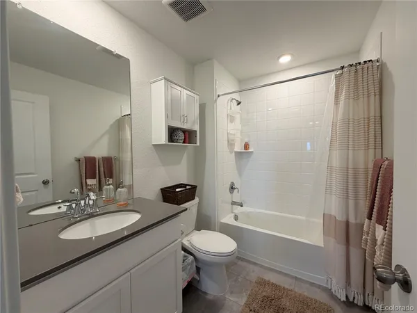 a bathroom with a sink toilet a shower and a mirror
