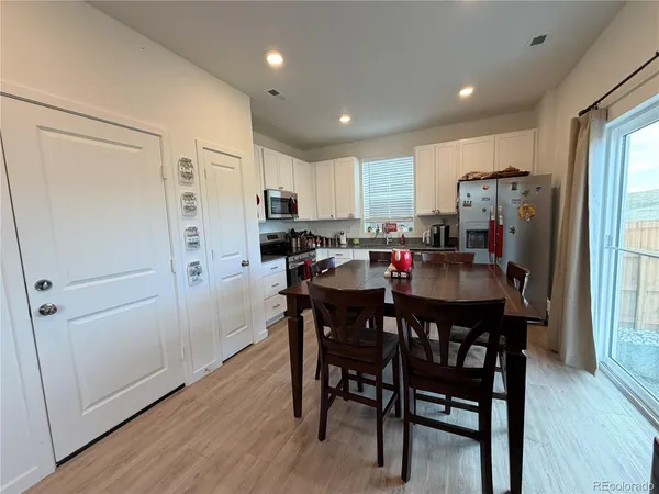 a view of a dining room with furniture and wooden floor