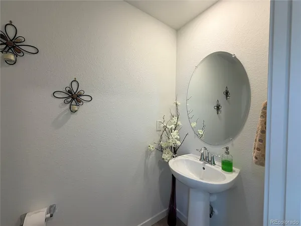 a bathroom with a sink mirror and toilet