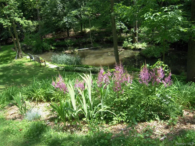 a backyard of a house with lots of green space and garden