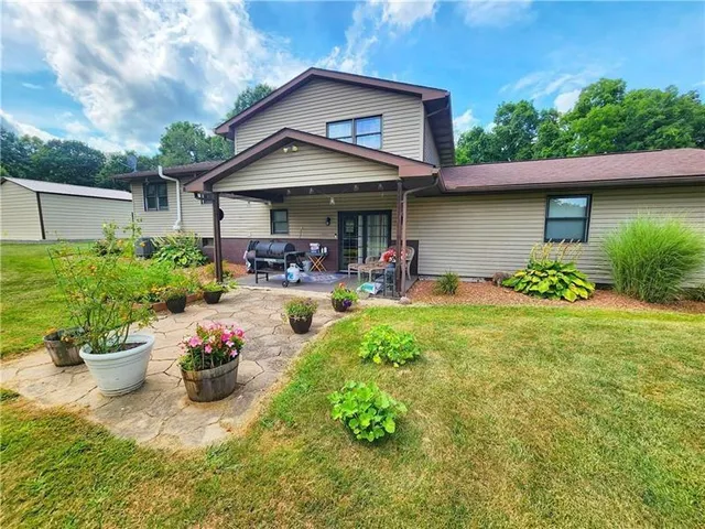 a front view of a house with sitting area