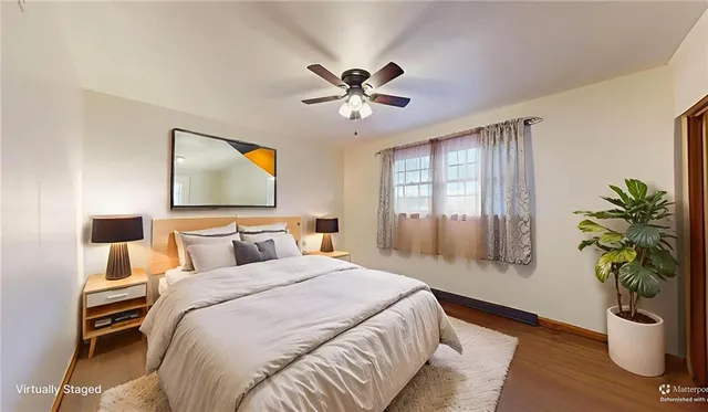 a bedroom with a bed and a potted plant