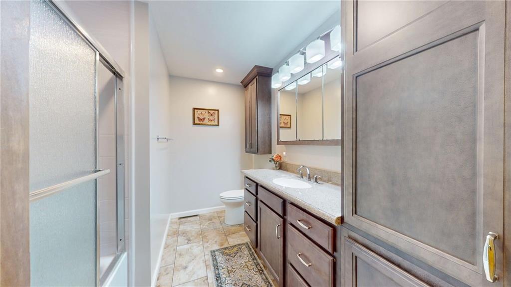 130 James Circle New Castle, PA 16102 - Photo 8 of 24 a bathroom with a granite countertop sink a mirror and a shower