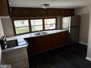 a kitchen with a sink and a refrigerator