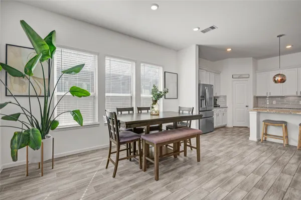 a kitchen with stainless steel appliances granite countertop a sink a stove and a refrigerator