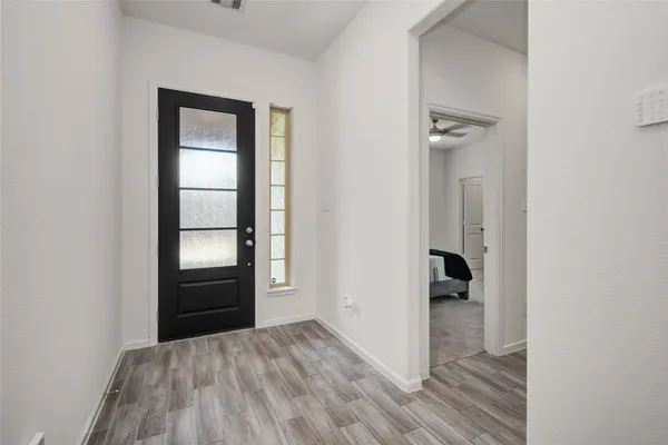 an empty room with windows and closet