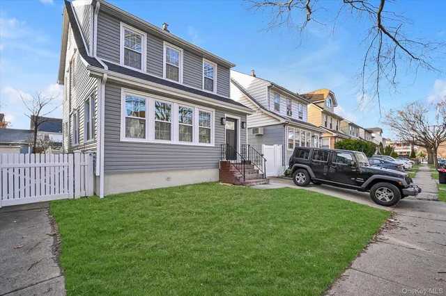 a view of a house with a yard and sitting area