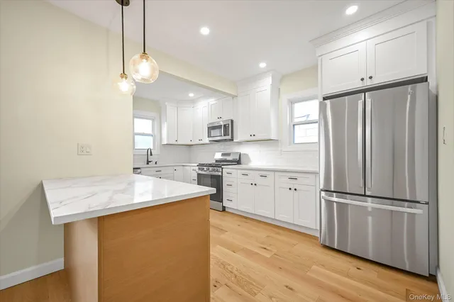 a kitchen with a refrigerator a sink and cabinets