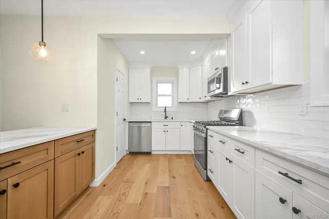 a kitchen with cabinets oven and a sink