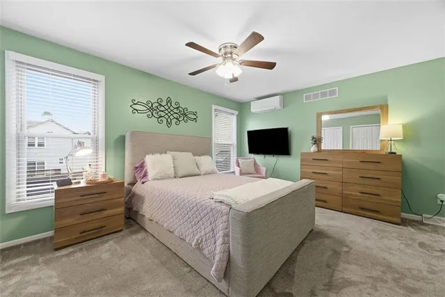 a spacious bedroom with a large bed and a flat screen tv