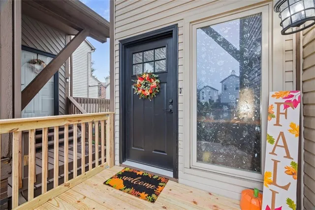a view of entryway with a front door and wooden floor