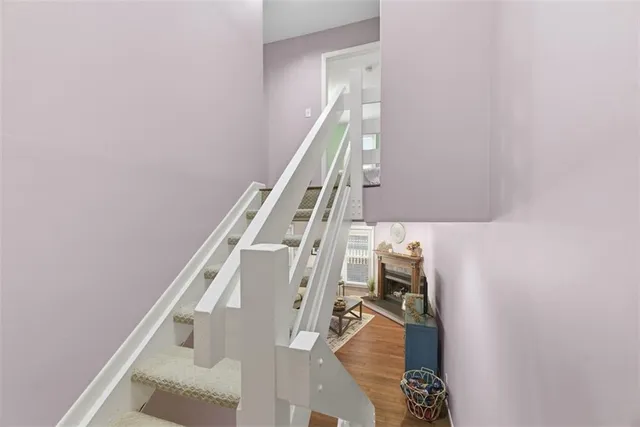 a view of entryway and hall with wooden floor