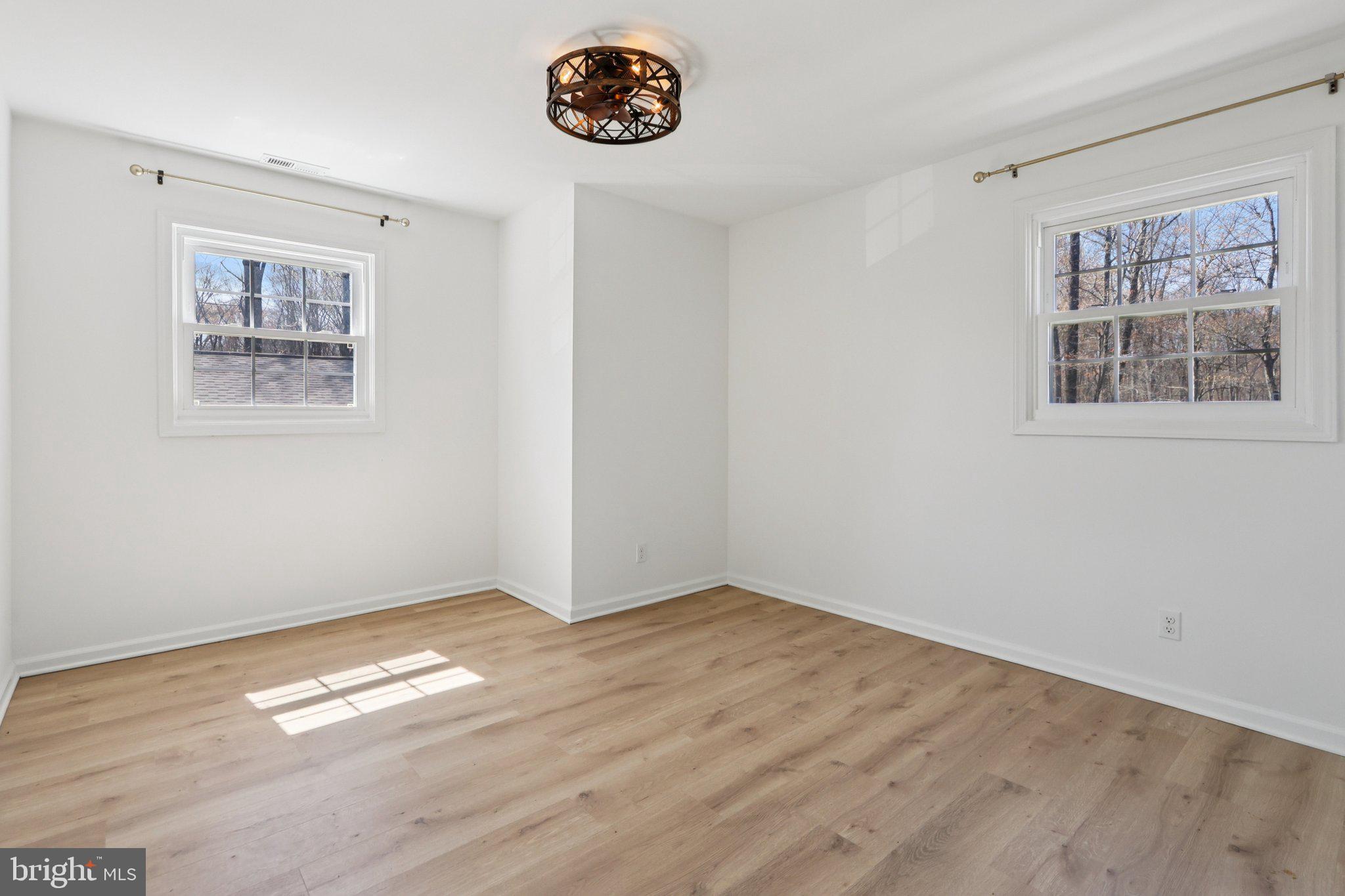 351 Merrick Road Robbinsville, NJ 08691 - Photo 41 of 69 a view of empty room with window and wooden floor