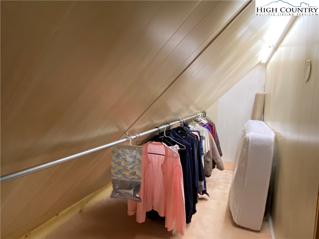 2446 3 Top Road Creston, NC 28615 - Photo 15 of 22 a view of walk in closet with clothes and shoes