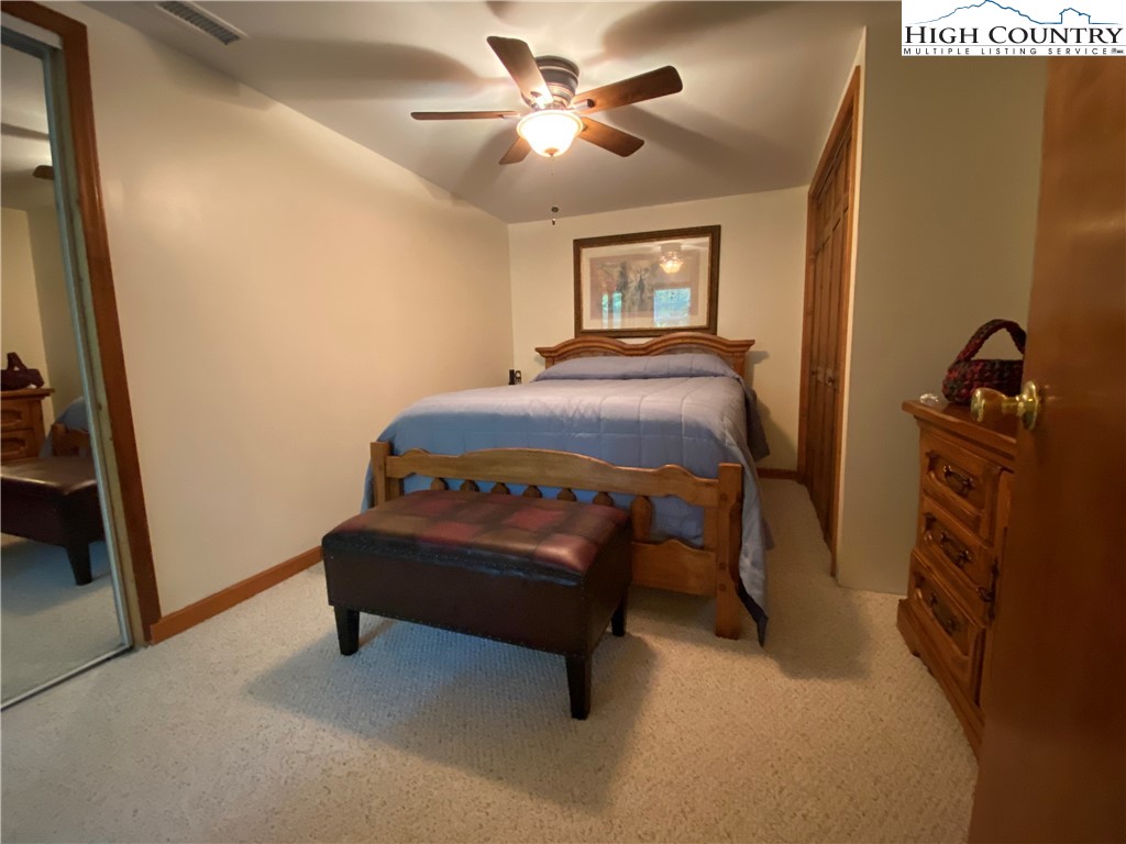 2446 3 Top Road Creston, NC 28615 - Photo 17 of 22 a bedroom with a bed and a chandelier