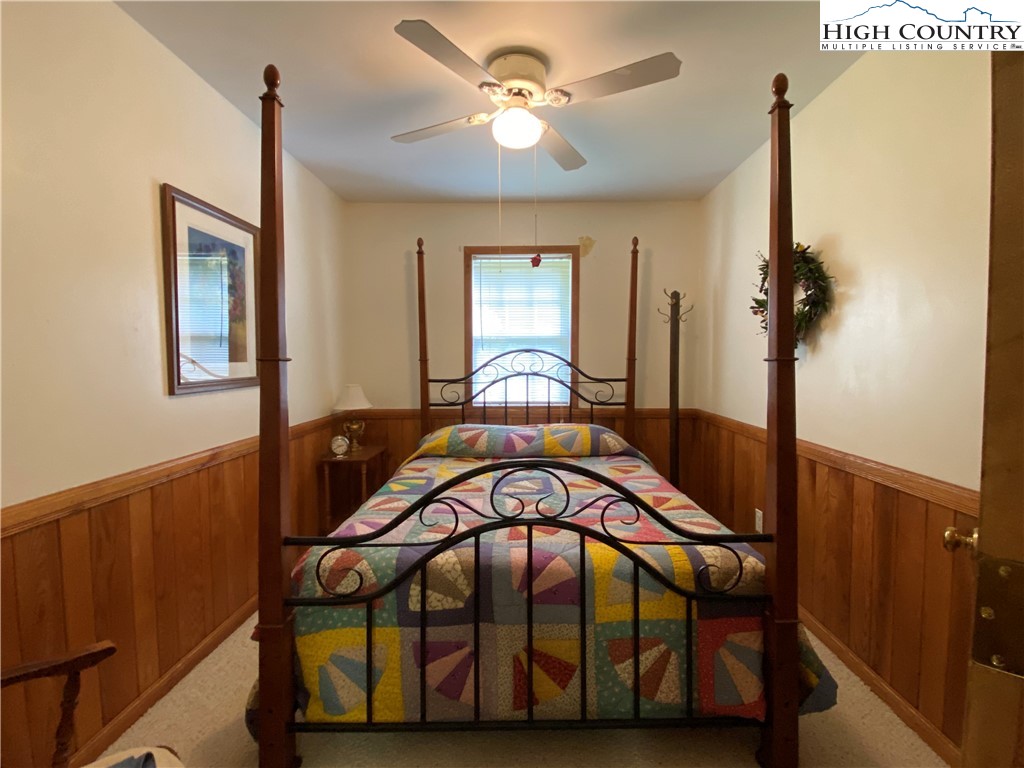 2446 3 Top Road Creston, NC 28615 - Photo 21 of 22 a bedroom with a bed and a chandelier