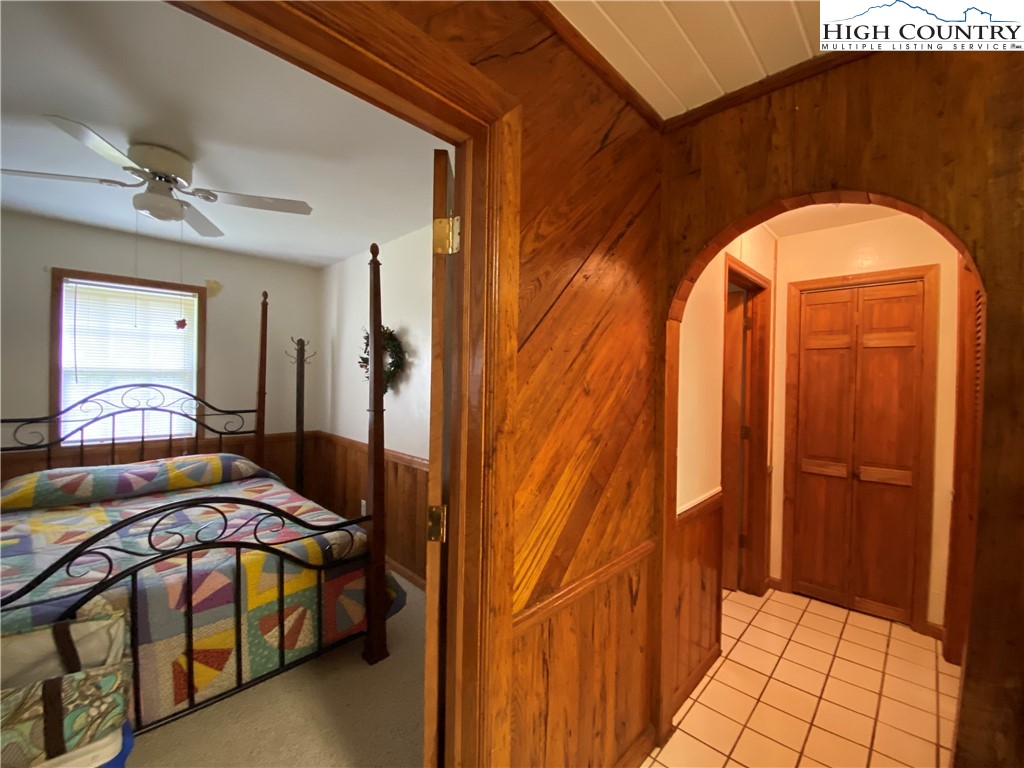 2446 3 Top Road Creston, NC 28615 - Photo 22 of 22 a bedroom with a bed and a mirror