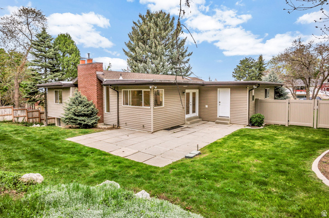 1320 Canyon Park Road Bountiful, UT 84010 - Photo 23 of 28 Back of house featuring a fenced backyard, a patio, a gate, and a chimney